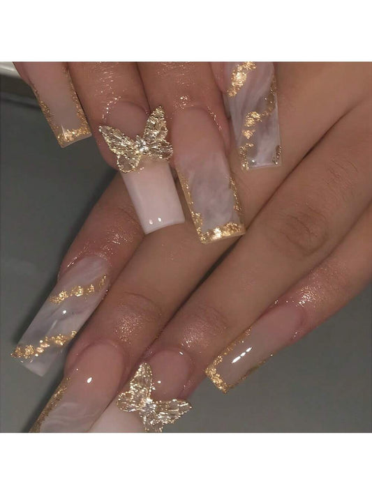 Faux ongles couleur champagne motif papillon